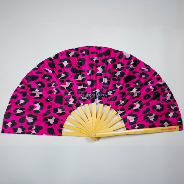 Hot pink leopard print bamboo clack fan with bold pink and black pattern. Large folding festival hand fan perfect for Pride, raves, drag shows and queer nightlife.