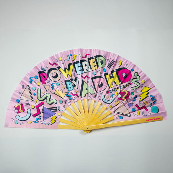 Powered by ADHD bamboo clack fan by Harlem Starlet, a bold neurodivergent statement hand fan perfect for Pride festivals, raves, queer events and ADHD babes who love funny statement fans.