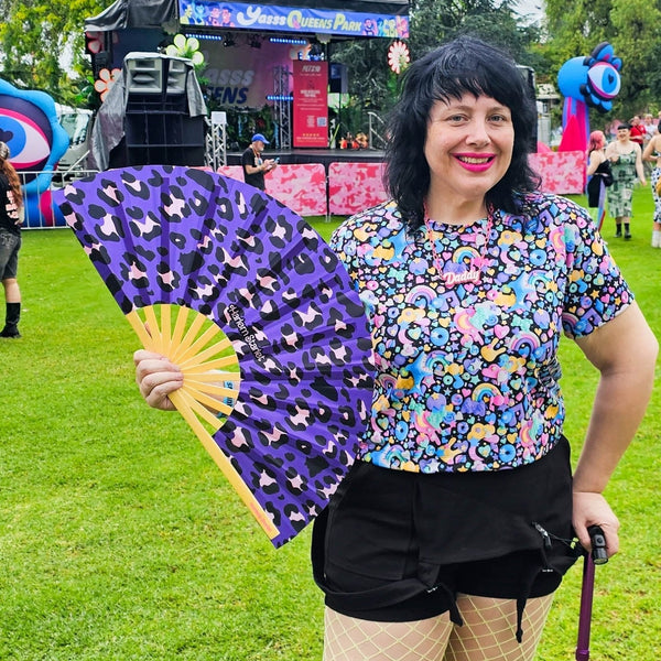 Purple leopard print bamboo clack fan with bold pink and black pattern. Large folding festival hand fan perfect for Pride, doofs, festivals, weddings, raves, drag shows and queer nightlife.