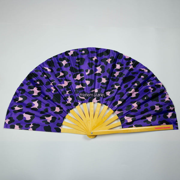 Purple leopard print bamboo clack fan with bold pink and black pattern. Large folding festival hand fan perfect for Pride, doofs, festivals, weddings, raves, drag shows and queer nightlife.
