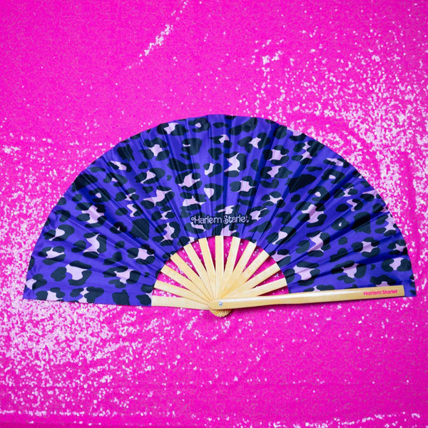 Purple leopard print bamboo clack fan with bold pink and black pattern. Large folding festival hand fan perfect for Pride, doofs, festivals, weddings, raves, drag shows and queer nightlife.