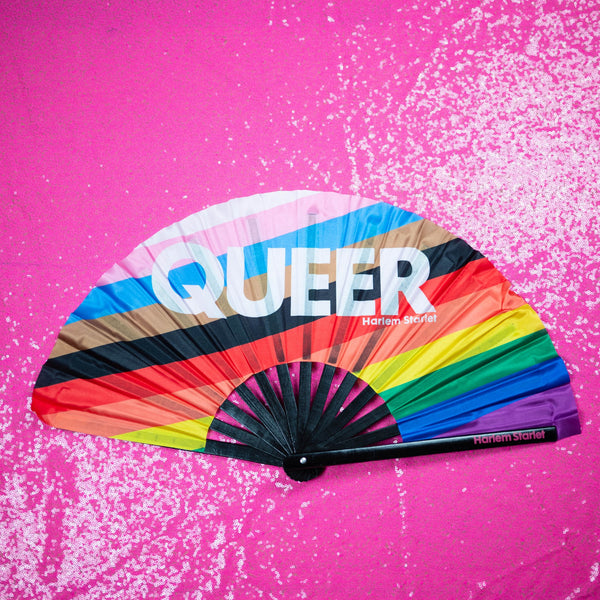 Queer Progress Pride Flag bamboo clack fan featuring the inclusive rainbow Pride colours, perfect for Pride festivals, marches, queer events and LGBTQIA+ celebrations.